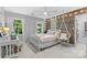 Stylish bedroom with large windows, a hanging chair, and a modern accent wall at 3717 Bounty Ct, Matthews, NC 28104