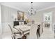 Formal dining room with elegant chandelier, stylish table setting, and serene decor at 3717 Bounty Ct, Matthews, NC 28104