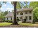 Attractive two-story white brick home displaying a lush lawn, tidy landscaping, and inviting entrance at 3717 Bounty Ct, Matthews, NC 28104