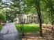 Two-story home with mature trees and a manicured lawn and a circular drive at 3717 Bounty Ct, Matthews, NC 28104