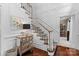 Elegant foyer featuring hardwood floors, white staircase, mirrored chest of drawers, and decorative accents at 3717 Bounty Ct, Matthews, NC 28104
