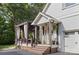Inviting front entrance with covered porch and outdoor seating area and flower pots at 3717 Bounty Ct, Matthews, NC 28104