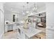 Modern kitchen featuring a marble-topped island, stainless steel appliances, and a seamless connection to the living area at 3717 Bounty Ct, Matthews, NC 28104