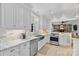 Modern kitchen boasts stainless steel appliances, marble countertops, and seamless flow to the living room at 3717 Bounty Ct, Matthews, NC 28104