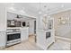 Bright kitchen featuring a large island with seating, stainless steel oven, and an open view to the living room at 3717 Bounty Ct, Matthews, NC 28104