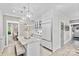 An open-concept kitchen with a marble island, stainless steel refrigerator, and modern pendant lighting fixtures at 3717 Bounty Ct, Matthews, NC 28104