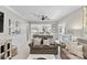 Open living room showcasing modern furniture, a view to the kitchen and plenty of natural light at 3717 Bounty Ct, Matthews, NC 28104