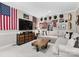 Comfortable living room featuring a sectional sofa, brick accent wall, and distinctive decor at 3717 Bounty Ct, Matthews, NC 28104