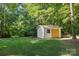 Backyard shed with double doors for additional storage on a lush, green lawn at 3717 Bounty Ct, Matthews, NC 28104