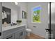 Bright bathroom featuring a vanity with modern fixtures and a window with natural light at 3953 Plainview Rd, Charlotte, NC 28208
