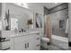 Modern bathroom with white vanity, sleek fixtures, and tiled shower-tub combination at 3953 Plainview Rd, Charlotte, NC 28208