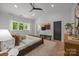Spacious bedroom featuring high ceilings, a ceiling fan, a large window, and neutral decor at 3953 Plainview Rd, Charlotte, NC 28208