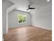 Minimalist bedroom bathed in natural light with a ceiling fan and hardwood floors at 3953 Plainview Rd, Charlotte, NC 28208