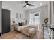 Bright bedroom with a ceiling fan, natural light, and modern decor elements that enhances a cozy atmosphere at 3953 Plainview Rd, Charlotte, NC 28208