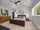 This primary bedroom boasts a ceiling fan, natural light, carpet, and modern decor accents at 3953 Plainview Rd, Charlotte, NC 28208