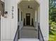 Inviting front porch with elegant black railings and door, creating a sophisticated entrance to the home at 3953 Plainview Rd, Charlotte, NC 28208