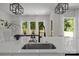 Bright kitchen with white countertops, modern fixtures, lighting, and a view to the backyard at 3953 Plainview Rd, Charlotte, NC 28208