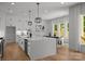 Modern kitchen with sleek countertops, stainless steel appliances, and an island, flowing into a dining area at 3953 Plainview Rd, Charlotte, NC 28208