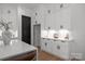 Bright and modern kitchen with custom white cabinets, white countertop, and stylish decor at 3953 Plainview Rd, Charlotte, NC 28208