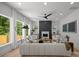 Bright living room featuring a decorative fireplace, large windows, and comfortable seating at 3953 Plainview Rd, Charlotte, NC 28208
