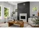 Cozy living room featuring a modern fireplace, comfortable seating, and natural light at 3953 Plainview Rd, Charlotte, NC 28208