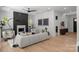 Bright living room with a decorative fireplace, comfortable seating and light hardwood floors at 3953 Plainview Rd, Charlotte, NC 28208