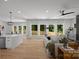 Open-concept living room featuring hardwood floors, a fireplace, and natural light at 3953 Plainview Rd, Charlotte, NC 28208