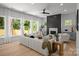 Bright living room showcasing a decorative fireplace, large windows, and sleek hardwood floors at 3953 Plainview Rd, Charlotte, NC 28208