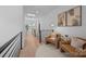 Cozy loft area with comfortable seating, modern railings, and ample natural light from the skylight at 3953 Plainview Rd, Charlotte, NC 28208