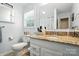 Bathroom with granite vanity, white cabinets, toilet, and a large mirror at 402 Walnut St, China Grove, NC 28023