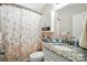 Bathroom featuring a granite vanity, toilet, shower curtain, and wall mirror at 402 Walnut St, China Grove, NC 28023