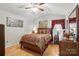 Cozy bedroom with wood floors, a bed with decorative pillows, and natural light at 402 Walnut St, China Grove, NC 28023