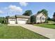 Charming home featuring an attached three-car garage and a well-manicured lawn at 402 Walnut St, China Grove, NC 28023