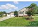 Beautiful home showcasing an attached three-car garage, and a neatly maintained lawn at 402 Walnut St, China Grove, NC 28023