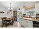 Bright kitchen nook with chandelier, dining table, and sliding door to outdoor patio at 402 Walnut St, China Grove, NC 28023