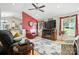 Cozy living room featuring hardwood floors, a ceiling fan, and ample seating at 402 Walnut St, China Grove, NC 28023