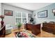 Bright office space featuring hardwood floors, desk, chair, and large window at 402 Walnut St, China Grove, NC 28023