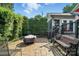 Cozy backyard patio area featuring stone pavers, seating, and lush greenery perfect for outdoor living at 402 Walnut St, China Grove, NC 28023