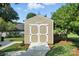 Close up of shed with unique door in backyard with a cement path at 402 Walnut St, China Grove, NC 28023