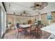 Charming sunroom with brick floors, a dining table, ceiling fans, and natural light at 402 Walnut St, China Grove, NC 28023