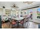 Bright sunroom featuring tiled floors, a dining table, ceiling fans, and natural light at 402 Walnut St, China Grove, NC 28023