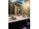 Bathroom with a double-sink vanity, large mirror, and storage at 404 Long Shoals Rd, Bessemer City, NC 28016