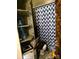 Bathroom featuring a toilet, shower/tub with curtain, and a glass door storage cabinet at 404 Long Shoals Rd, Bessemer City, NC 28016