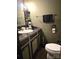 Bathroom with olive green walls and black painted vanity at 404 Long Shoals Rd, Bessemer City, NC 28016