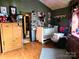 Cozy Bedroom featuring wood floors, a crib, and ample storage at 404 Long Shoals Rd, Bessemer City, NC 28016