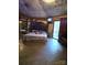 A spacious bedroom featuring a large bed, unique textured ceiling, and access to the outdoors at 404 Long Shoals Rd, Bessemer City, NC 28016
