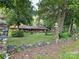 Unique home with stone wall and ballustrades, wooded surrounding, and unusual roofline at 404 Long Shoals Rd, Bessemer City, NC 28016