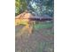 Unique circular home features a brown roof and manicured lawn, nestled among mature trees at 404 Long Shoals Rd, Bessemer City, NC 28016