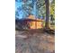 Side-view of a distinctive home with a unique architectural roof, paired with a stone wall and rustic setting at 404 Long Shoals Rd, Bessemer City, NC 28016