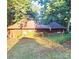 Exterior view of unique house with rounded roof, surrounded by trees, and featuring an American flag at 404 Long Shoals Rd, Bessemer City, NC 28016